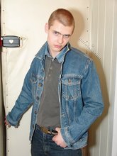 Denim-loving guy posing outdoors, looking mean/lean