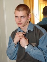 Denim-loving guy posing outdoors, looking mean/lean