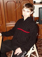 Dark-haired twink posing shirtless in his own room