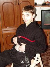 Dark-haired twink posing shirtless in his own room