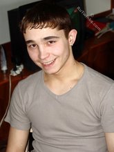 Dark-haired twink posing shirtless in his own room