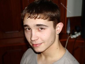 Dark-haired twink posing shirtless in his own room
