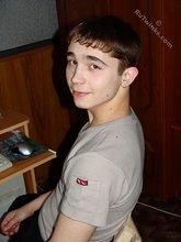 Dark-haired twink posing shirtless in his own room