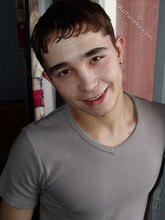 Dark-haired twink posing shirtless in his own room