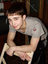 Dark-haired twink posing shirtless in his own room