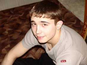 Dark-haired twink posing shirtless in his own room