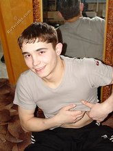 Dark-haired twink posing shirtless in his own room
