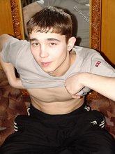 Dark-haired twink posing shirtless in his own room
