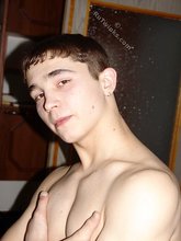 Brown-eyed twink posing half-naked and touching himself