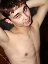 Brown-eyed twink posing half-naked and touching himself
