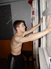 Brown-eyed twink posing half-naked and touching himself