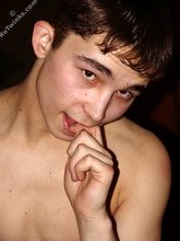 Brown-eyed twink posing half-naked and touching himself