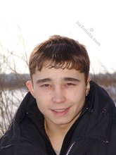 Gorgeous twink posing while squatting outdoors