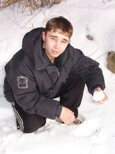 Gorgeous twink posing while squatting outdoors