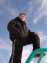 Gorgeous twink posing while squatting outdoors