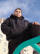 Gorgeous twink posing while squatting outdoors