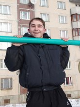 Gorgeous twink posing while squatting outdoors