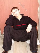 Gorgeous twink posing while squatting outdoors