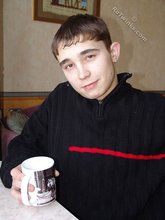 Gorgeous twink posing while squatting outdoors