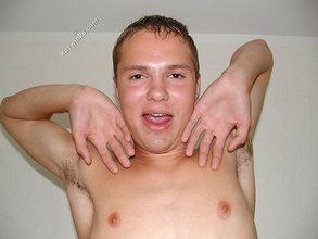 Blond-haired guy showing his feet and his ass