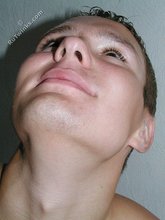 Submissive-looking twink doing splits on camera