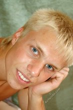 Blue-eyed and blond-haired hottie shows that ass