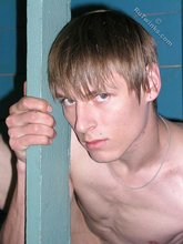 Dark-haired twink with piercing eyes showing his feet