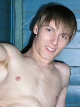 Dark-haired twink with piercing eyes showing his feet