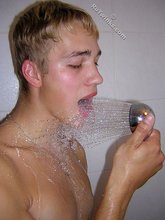 Blond-haired twink showering and looking seductive