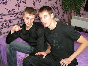 Two luxurious gay boys posing together on a bed