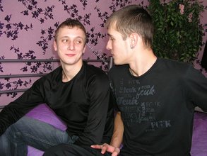 Two luxurious gay boys posing together on a bed