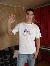 Dark-haired dude flips off the camera and puts on his shirt