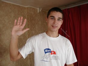 Dark-haired dude flips off the camera and puts on his shirt