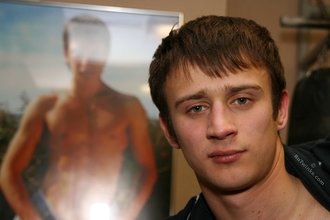 Sporty dark-haired twink takes his t-shirt off