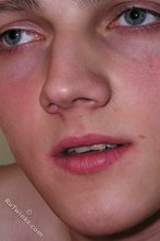 Blond-haired twink takes off his socks on camera