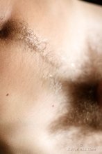 Curly-haired model showing his hairy cock and his pubes