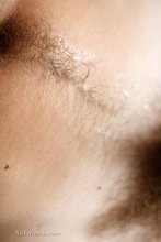 Curly-haired model showing his hairy cock and his pubes