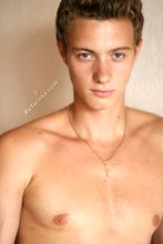 Curly-haired model showing his hairy cock and his pubes