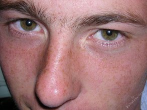 Green-eyed red-faced twink takes off his shirt