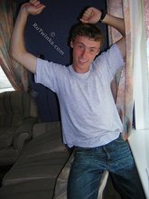 Green-eyed red-faced twink takes off his shirt