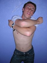 Green-eyed red-faced twink takes off his shirt