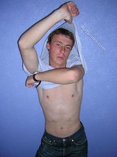 Green-eyed red-faced twink takes off his shirt