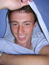 Green-eyed red-faced twink takes off his shirt