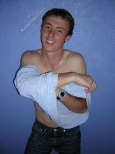 Green-eyed red-faced twink takes off his shirt