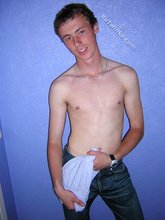 Green-eyed red-faced twink takes off his shirt