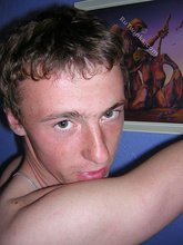 Green-eyed red-faced twink takes off his shirt