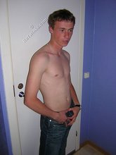 Green-eyed red-faced twink takes off his shirt