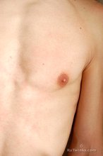 Toned twink with a beautiful cock is posing solo here