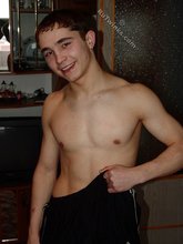 Dark-haired twink posing completely naked in the bathroom