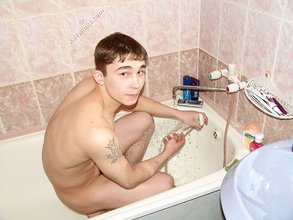 Dark-haired twink posing completely naked in the bathroom